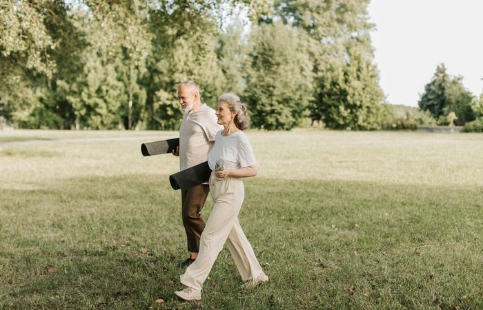 Smiling woman stretching outdoors feeling energized and happy.